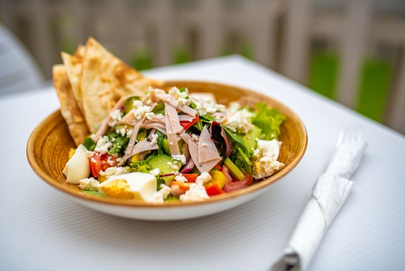 High-protein salad with ham, eggs, and pita bread
